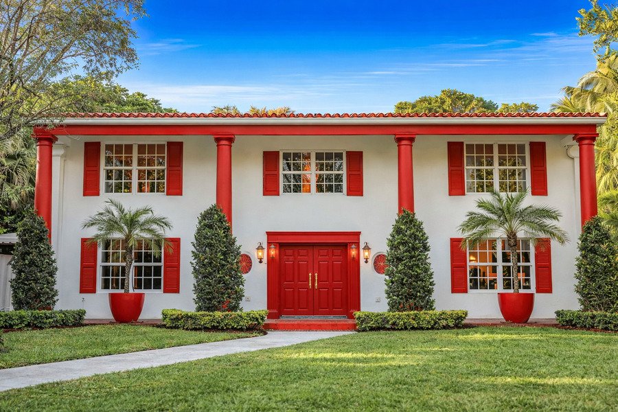 Subterranean Termite Treatment Cost Red house with white shutters and front door.
