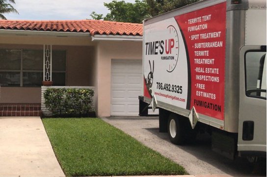 Termite Treatment & Pest Control​ Data-Based - Time’s Up fumigation truck parked at residential driveway.