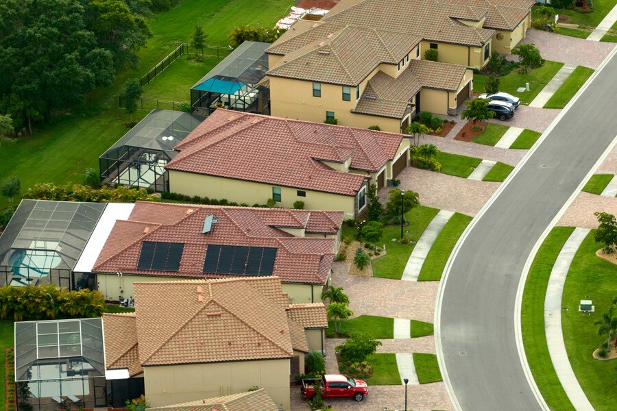 How long does termite treatment last - Aerial view of suburban houses with tiled roofs.