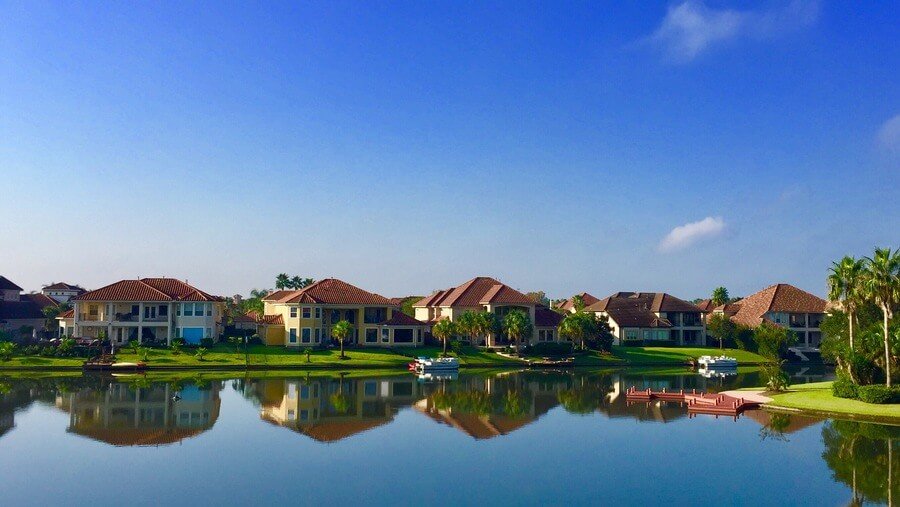 How often pest control should be done - Lakeside houses reflected on calm water