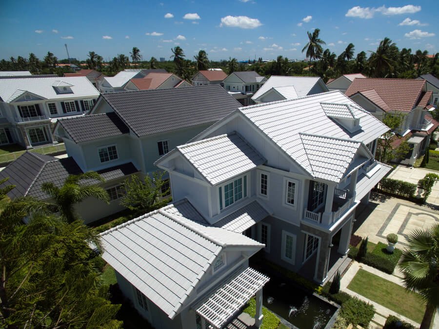 How to treat subterranean termites - Aerial view of residential houses with tiled roofs.