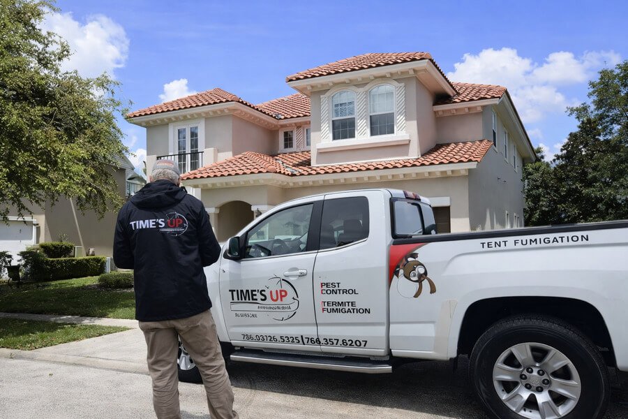 Tentless Termite Treatment - Pest control truck parked in front of residential home.